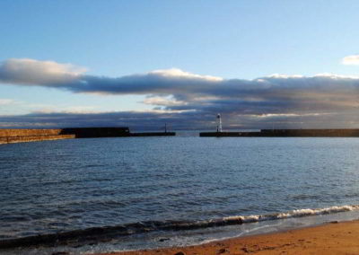 View across harbour area towards lighthouse.