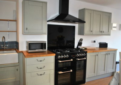 The open plan kitchen and dining room features a large double oven and hob.