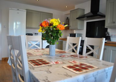 Six chair dining table with colourful flowers