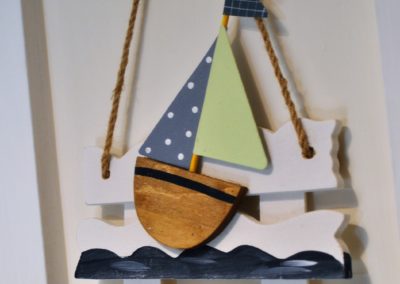 Wooden wall hanging of a boat on the waves