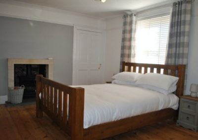 Ground floor double bedroom features a wood burning stove