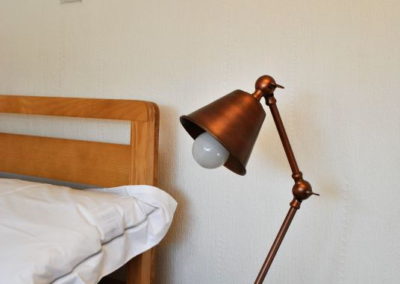 Copper lamp on a bedside table