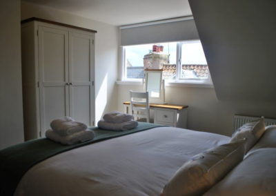 On the upper level, a comfortable kingsized bed (can be arranged as twin)