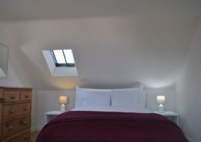 Double bed beneath a sloped ceiling
