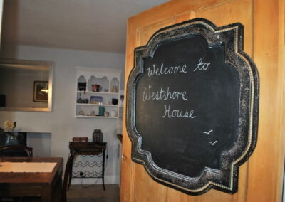 Sign on door reads: Welcome to Westshore House.
