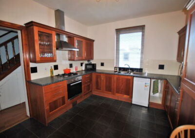 Tiled kitchen floor and window above sink