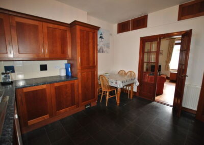 The kitchen has red wooden kitchen cabinet doors