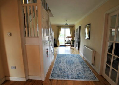 A large rug sits on the hallway floor.