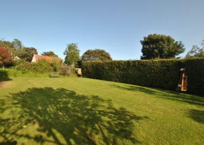 Large grass area and long hedge