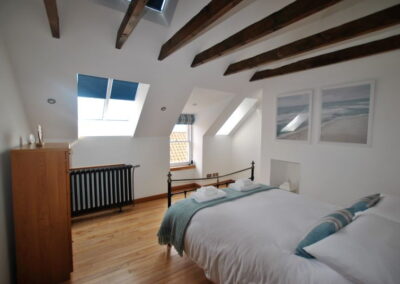Double bed beneath beamed ceiling