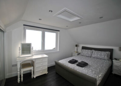 King size bed to right of window. Dressing table in front of window