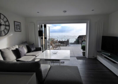 Looking over the sofa towards the sea. The glass doors are open to the patio.