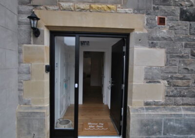 Wide front door with glass pane to left
