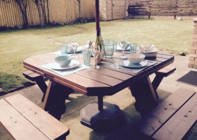 Wooden table set for four in garden