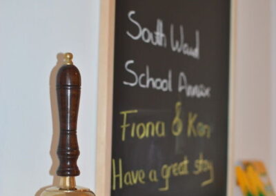 Brass bell next to a small blackboard