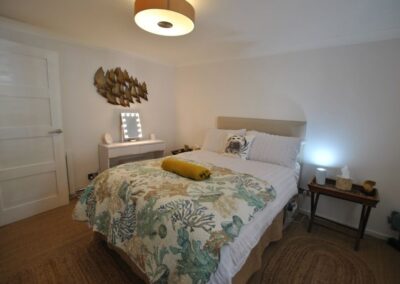 Double bed with dressing table to left and bedside table to right