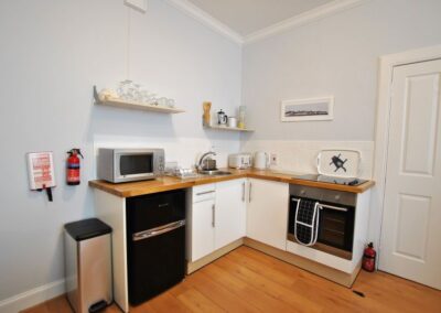 The kitchen has a fridge freezer, microwave and oven