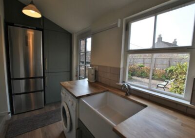 The utility room offers access to the garden as well as useful additional facilities