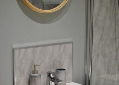 Round mirror above sink