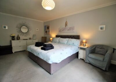 The calming colour scheme of bedroom 2 is fresh and light