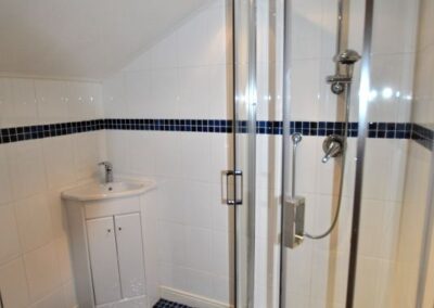 Tiled shower room with curved, walk-in shower