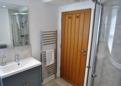 Wooden door next to heated towel rail