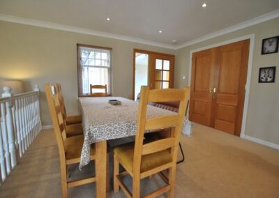 The dining area sits between the kitchen and lounge. The dining table extends to accommodate ten guests.