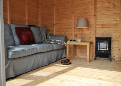 The summer house has sofas and provides a great extra space
