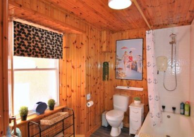 Wooden panelled walls and ceiling in bathroom