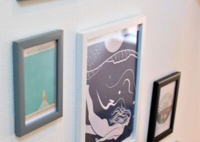 Framed prints on the wall showing coastal theme artwork