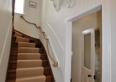 Beautiful wooden staircase with feature knot rope handrail