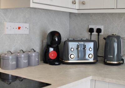 Close up of toaster, kettle, coffee, sugar and tea caddies