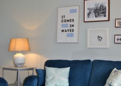 Sea related images on wall behind sofa