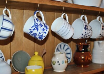 Mugs and tea-cups hang on hooks