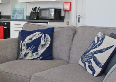 Grey sofa with cushions showing images of crabs