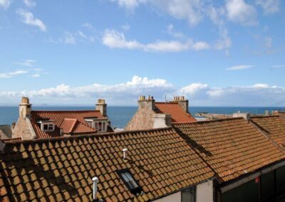 View over the red pantiles roofs towards the harbour and lighthouse on the pier