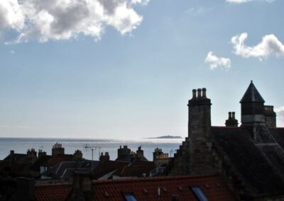 Silhouette of buildings looking towards the Isle of May, beneath a