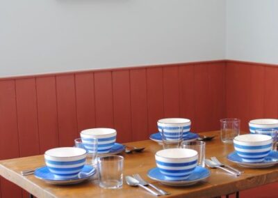 Close up of dining table set with blue and white bowls.