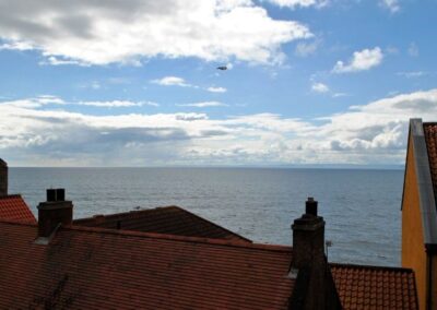 View across rooftop to sea.