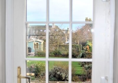 View of garden through nine-pane window in door