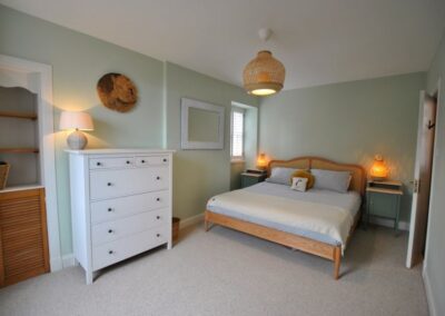 Calm-looking, light green bedroom.