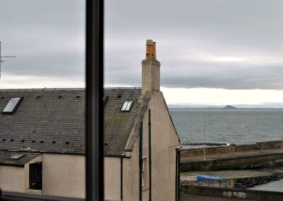 View through window across the Firth of Forth towards Berwick Law.