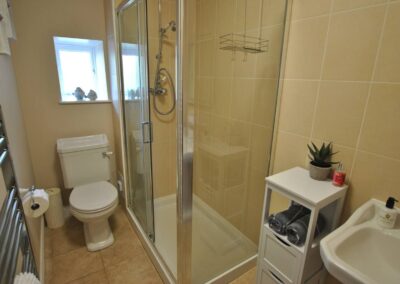 White bathroom suite with transparent shower cubicle.