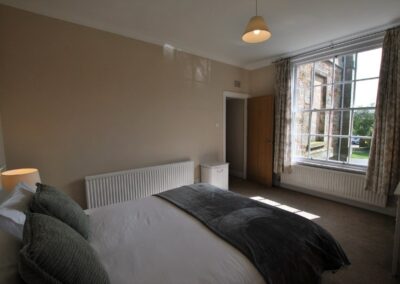 Double bed facing large window.