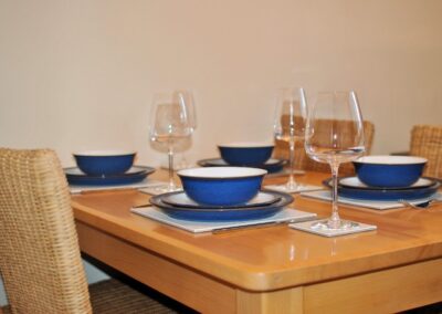 Close-up of blue and white crockery on table set for four.