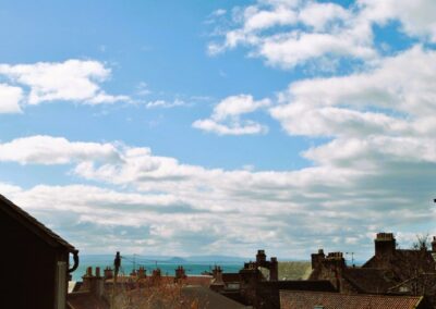 View over rooftops towards the sea and Berwick Law across the Firth of Forth.