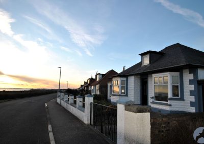 Exterior of house against an evening sunset.