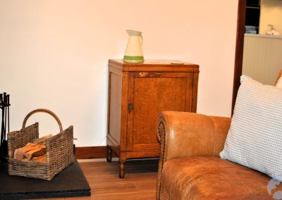 Leather sofa bear a wooden cabinet.