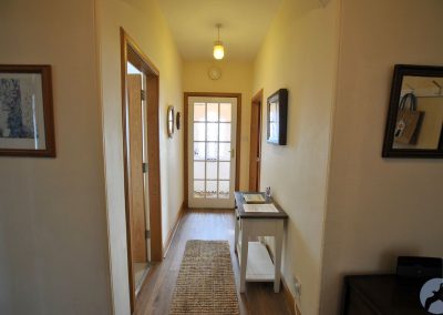 View down hallway towards front door.