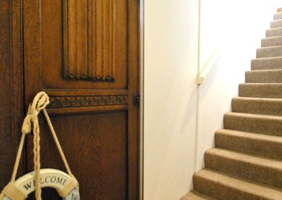 Open door leading to stairs going up.